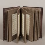 A Chinese folding book set with jade panels The covers with carved calligraphy. 22.5 cm high.