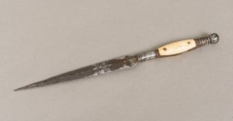 An 18th/19th century dagger With engraved blade and short carved ivory mounted handle. 30 cm long.