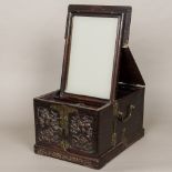 A late 19th century Chinese carved hardwood travelling dressing box The hinged top enclosing a