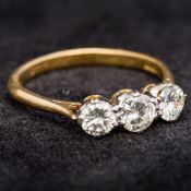 An 18 ct gold diamond three stone ring The central stone spreading to just under 0.