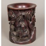 A Chinese carved hardwood brush pot Worked with a figure riding a water buffalo in a continuous