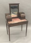 A 19th century French Empire brass mounted mahogany bonheur du jour The bevelled mirrored back