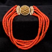 An five strand coral bead necklace Set with am 18 ct gold filigree clasp. Approximately 38 cm long.