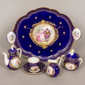 A 19th century Continental porcelain tea set Comprising: a tray, teapot, sucrier,