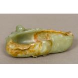A Chinese carved jade brush washer Formed as a small boy climbing on a side of a leaf. 13.