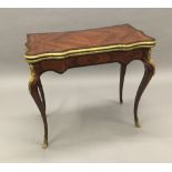 A 19th century gilt bronze mounted kingwood card table The shaped hinged rectangular top enclosing