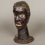 An African Ekoi tribal bust The naturalistic hide covered bust mounted on a woven plinth.