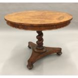 A 19th century pollard oak tilt-top tripod table The circular top above the barley twist column and