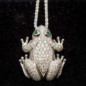 A 14 ct gold diamond and emerald set pendant on chain The pendant formed as a frog,