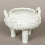 A Chinese blanc de chine porcelain censer Of squat circular form, with twin dragon handles,