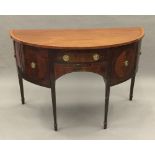 A 19th century satinwood banded and inlaid mahogany demi-lune sideboard/serving table Fitted with a