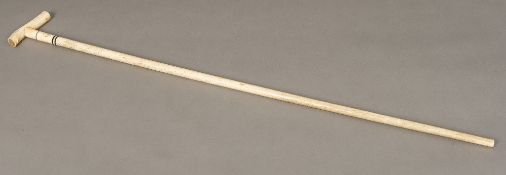 A 19th century ivory handled whale bone walking stick The handle set with ebony spacers above the