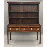 An 18th century and later oak dresser The rack with moulded cornice above two fixed shelves and