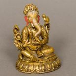 An Indian gilt bronze figure of Ganesh Of typical form, the head with painted detail. 9.5 cm high.
