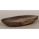 A Tami Islands wooden ceremonial food bowl Of rounded navette form, with typical carved decoration,