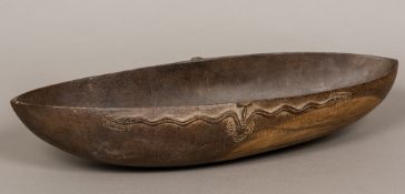 A Tami Islands wooden ceremonial food bowl Of rounded navette form, with typical carved decoration,