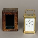 A 19th century French brass cased carriage timepiece The white enamelled dial with Roman numerals,