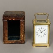 A 19th century French brass cased carriage timepiece The white enamelled dial with Roman numerals,