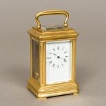 A miniature brass cased carriage clock The white enamelled dial with Roman numerals. 9.5 cm high.