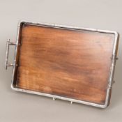 An early 20th century Japanese silver mounted hardwood tray The silver mounts formed as simulated