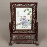 A Chinese porcelain mounted wooden framed table screen Worked with figures within a fenced garden