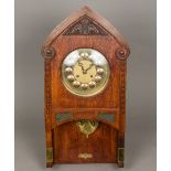 A Continental Arts & Crafts oak cased wall clock by Gustav Becker The 8 1/2 inch brass and copper
