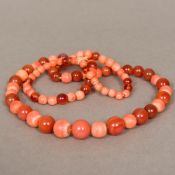 A coral and cornelian bead necklace Of graduated form. Approximately 73 cm long.