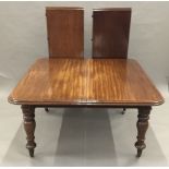 A Victorian mahogany extending dining table The rounded rectangular top incorporating two leaves