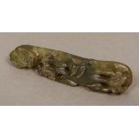 A Chinese carved jade belt hook Typically formed as a dragon. 11.75 cm long.