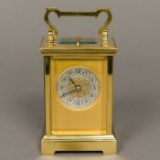 A 19th century brass cased hour repeating carriage clock The silvered dial with Arabic numerals