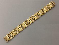 A Kordes & Lichtenfels 14 ct gold plated textured bracelet Of hinged sectional form,
