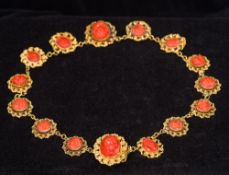 A 19th century unmarked high carat gold and coral necklace Each filigree link set with a classical