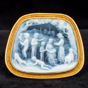 A carved hardstone cameo brooch Carved with various figures and animals before a castle in a