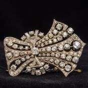 An Art Deco unmarked white gold or platinum diamond set brooch Of pierced waisted fan shape set