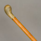 A late 19th/early 20th century Continental 18 ct gold mounted rhino horn handled malacca cane