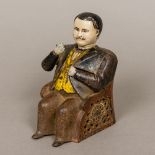 A painted cast iron Tammany money bank Modelled as a seated moustachioed nodding gentleman.