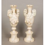 A pair of 19th century alabaster vases Each of twin handled form with carved floral decorations.