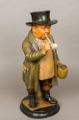 A 19th century painted terracotta figure of a country gentleman Smoking a pipe and drinking ale