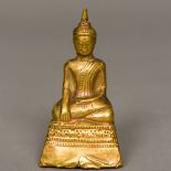 A Sino-Tibetan small antique unmarked high carat gold clad Buddha Typically modelled seated in the