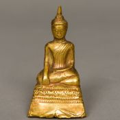 A Sino-Tibetan small antique unmarked high carat gold clad Buddha Typically modelled seated in the