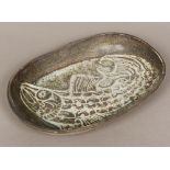 A pottery dish Of rounded rectangular form, decorated within the glaze with a fish. 43.5 cm wide.