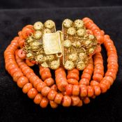 A four strand coral bead necklace Set with an 18 ct gold filigree clasp. Approximately 29 cm long.