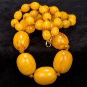 A butterscotch amber bead necklace Of graduated form. Approximately 66 cm long.