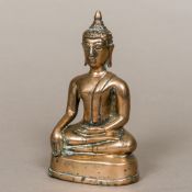 An antique bronze Buddha Typically modelled seated in the lotus position wearing a headdress.