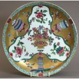 A Chinese porcelain dished plate, probably 18th century Well painted with a basket of flowers,