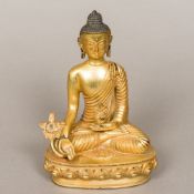 A gilt bronze model of Buddha Typically modelled seated in the lotus position holding a flower and