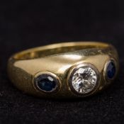 A diamond and sapphire gypsy set 14 ct gold ring The central stone approximately 0.5 carat.