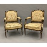 A pair of 19th century French upholstered carved giltwood open armchairs Each arched padded back