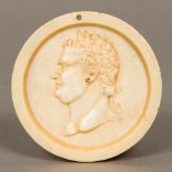 A 19th century carved ivory roundel Of dished form, centred with a male bust,