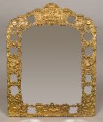 A large late 19th/early 20th century Continental repousse brass framed strut mirror Decorated with